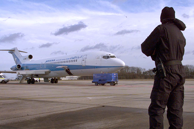 An Essex policeman stands guard over the hijacked Ariana plane at Stansted airport, February 10. The five-day hijack ended peacefully just before dawn without any casualties among the 150 people on board. - RTXJI3G