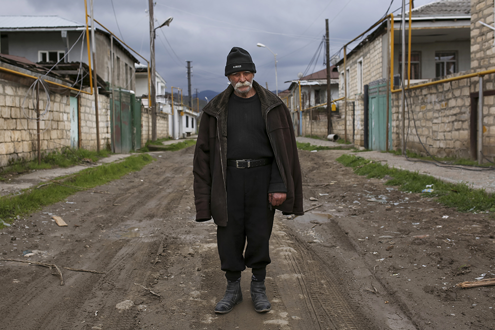 Vagho Beglaryan, 92, an elderly ethnic Armenian man stands in the center of an empty street between abandoned and destroyed houses during the fighting in Martakert province in the separatist region of Nagorno-Karabakh, Azerbaijan, Monday, April 4, 2016. Fighting raged Monday around Nagorno-Karabakh, with Azerbaijan saying it lost three of its troops in the separatist region while inflicting heavy casualties on Armenian forces and the Armenian president warning that the hostilities could slide into a full-scale war. (Vahan Stepanyan, PAN Photo via AP)