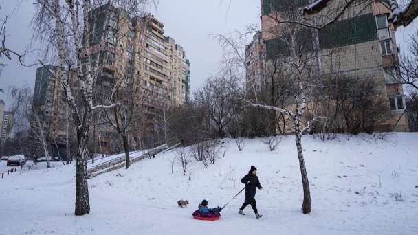 Женщина с ребенком в жилом районе Киева. (Фото Evgeniy Maloletka AP / TASS)